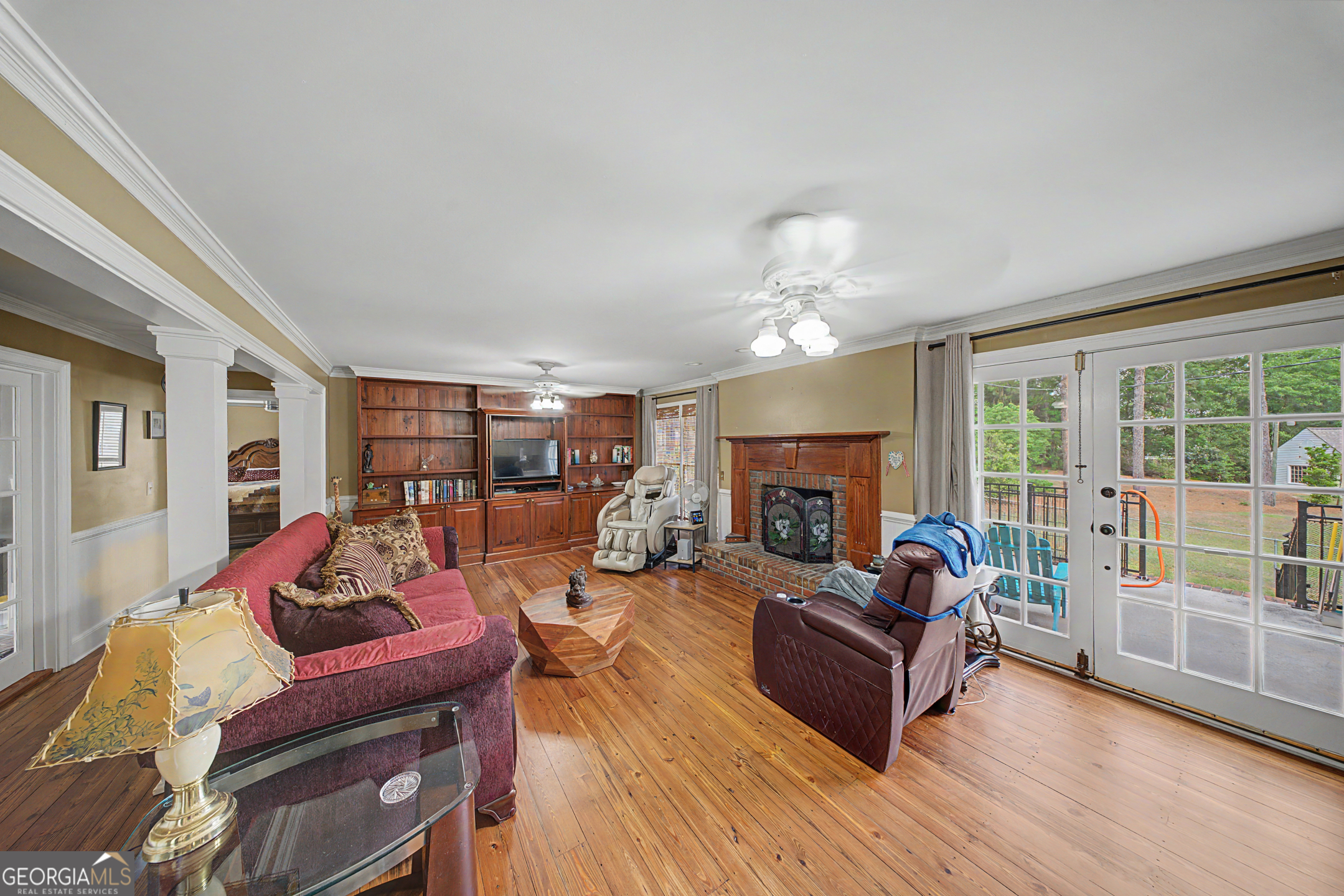 306 Holly Trail Moultrie, GA 31768 - Photo 16 of 40 a living room with furniture a fireplace and a large window
