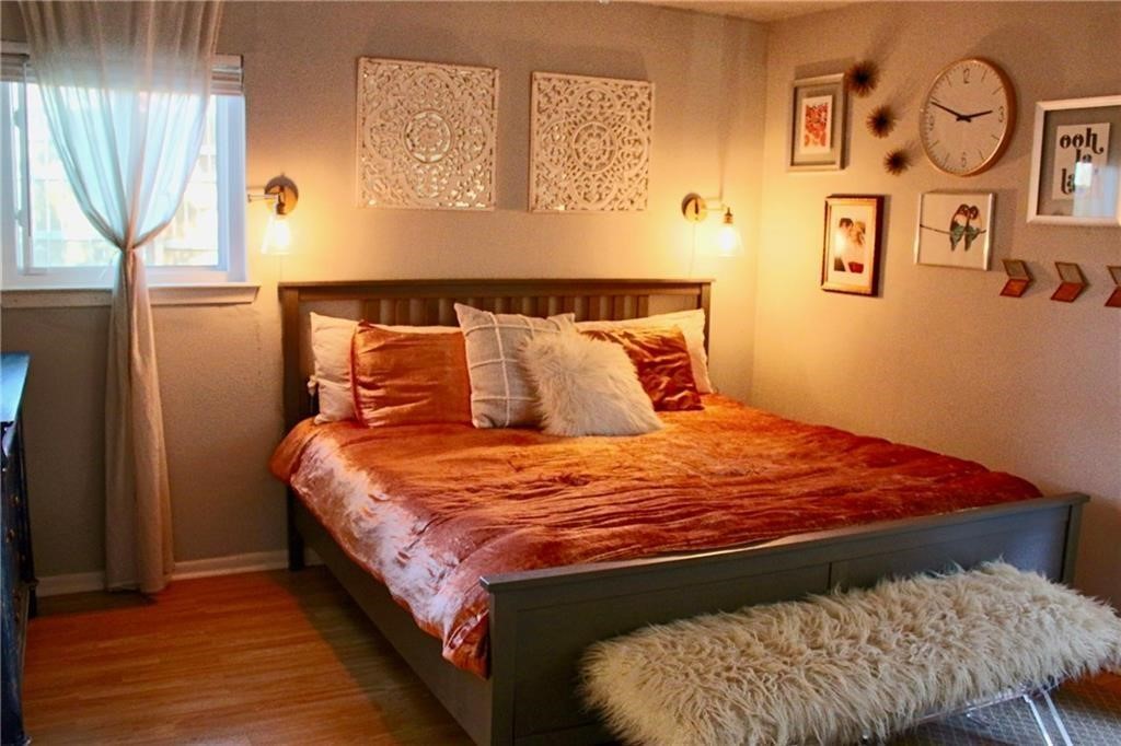 1511 Rutland Drive, Unit A Austin, TX 78758 - Photo 10 of 16 a bed sitting in a bedroom next to a window
