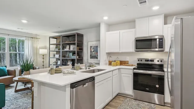 a kitchen with a sink stainless steel appliances and white cabinets