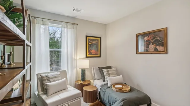 a living room with furniture and a large window