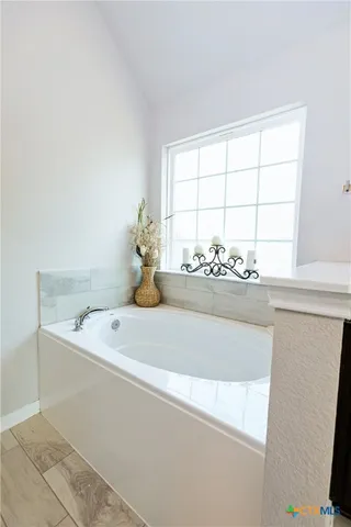 a bathroom with a sink and a window