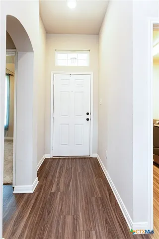 an empty room with wooden floor and closet