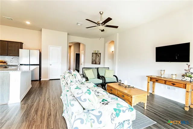 a bedroom with furniture and a flat screen tv