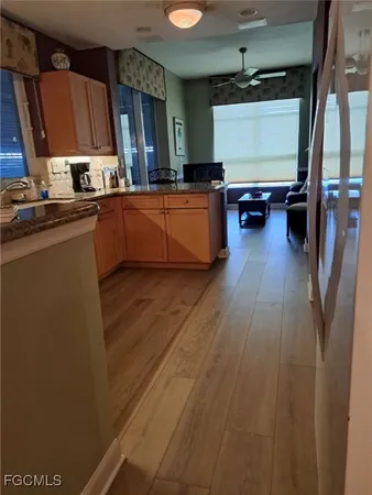 a kitchen with wooden floors and a sink