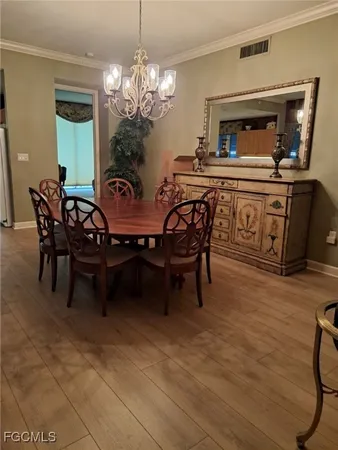 a dining room with furniture and chandelier