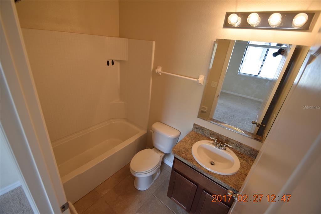 5221 Windsor Lake Circle Sanford, FL 32773 - Photo 12 of 15 a bathroom with a sink a toilet and shower