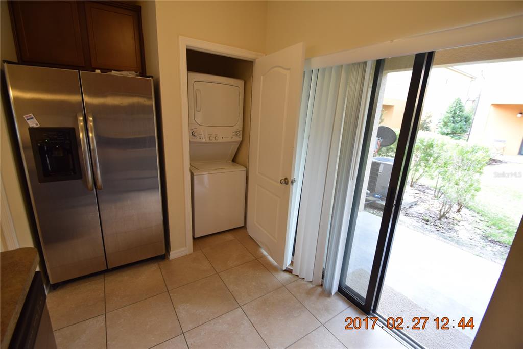 5221 Windsor Lake Circle Sanford, FL 32773 - Photo 6 of 15 a view of a refrigerator in kitchen and an empty room