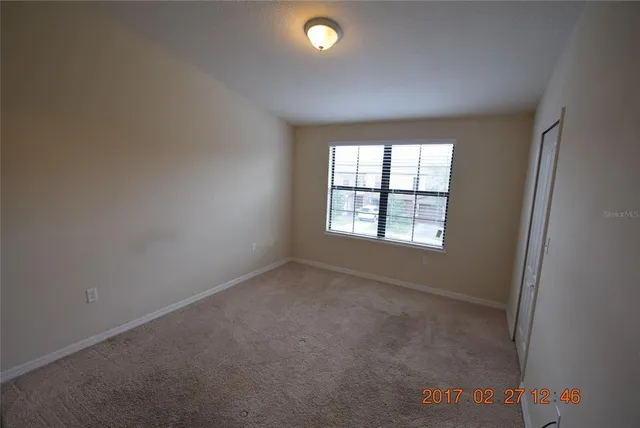 an empty room with windows and entrance