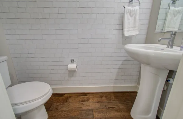 a bathroom with a sink a toilet and a mirror