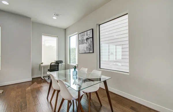 a view of a dining room with furniture and wooden floor