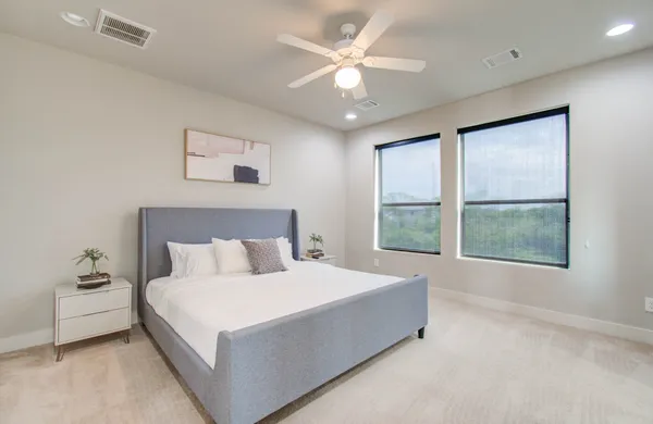 a large bed sitting in a bedroom next to a window
