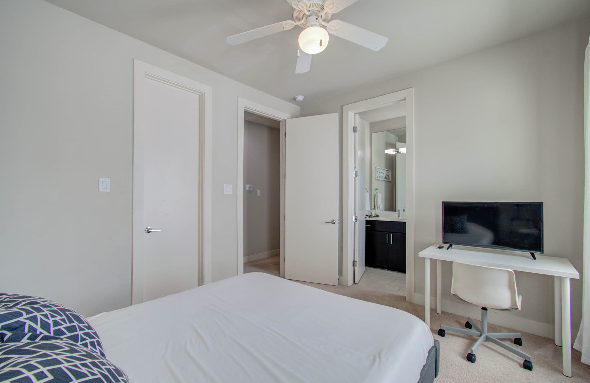 509 Gregg Street Houston, TX 77020 - Photo 33 of 38 a bedroom with a bed and a flat tv screen on the dresser