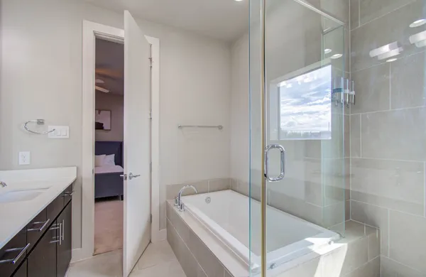 a bathroom with a tub a sink and a shower
