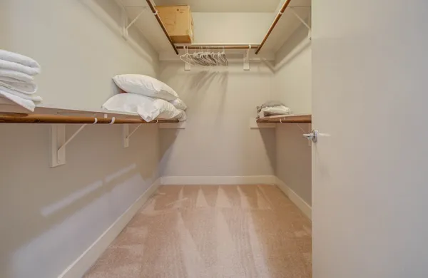 a view of walk in closet with empty racks