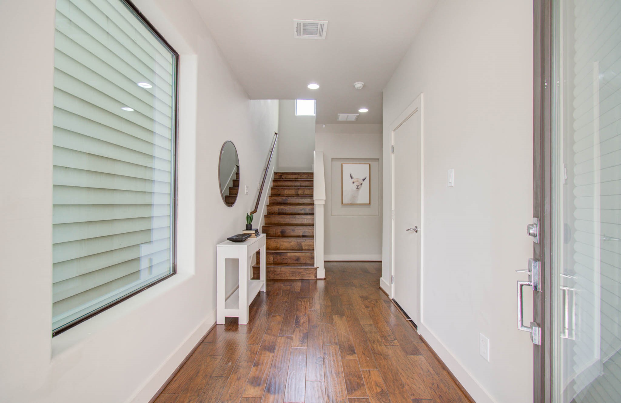 509 Gregg Street Houston, TX 77020 - Photo 5 of 38 a view of a hallway with wooden floor and staircase