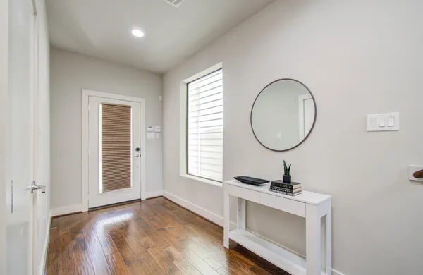 a view of a room with a mirror and a window