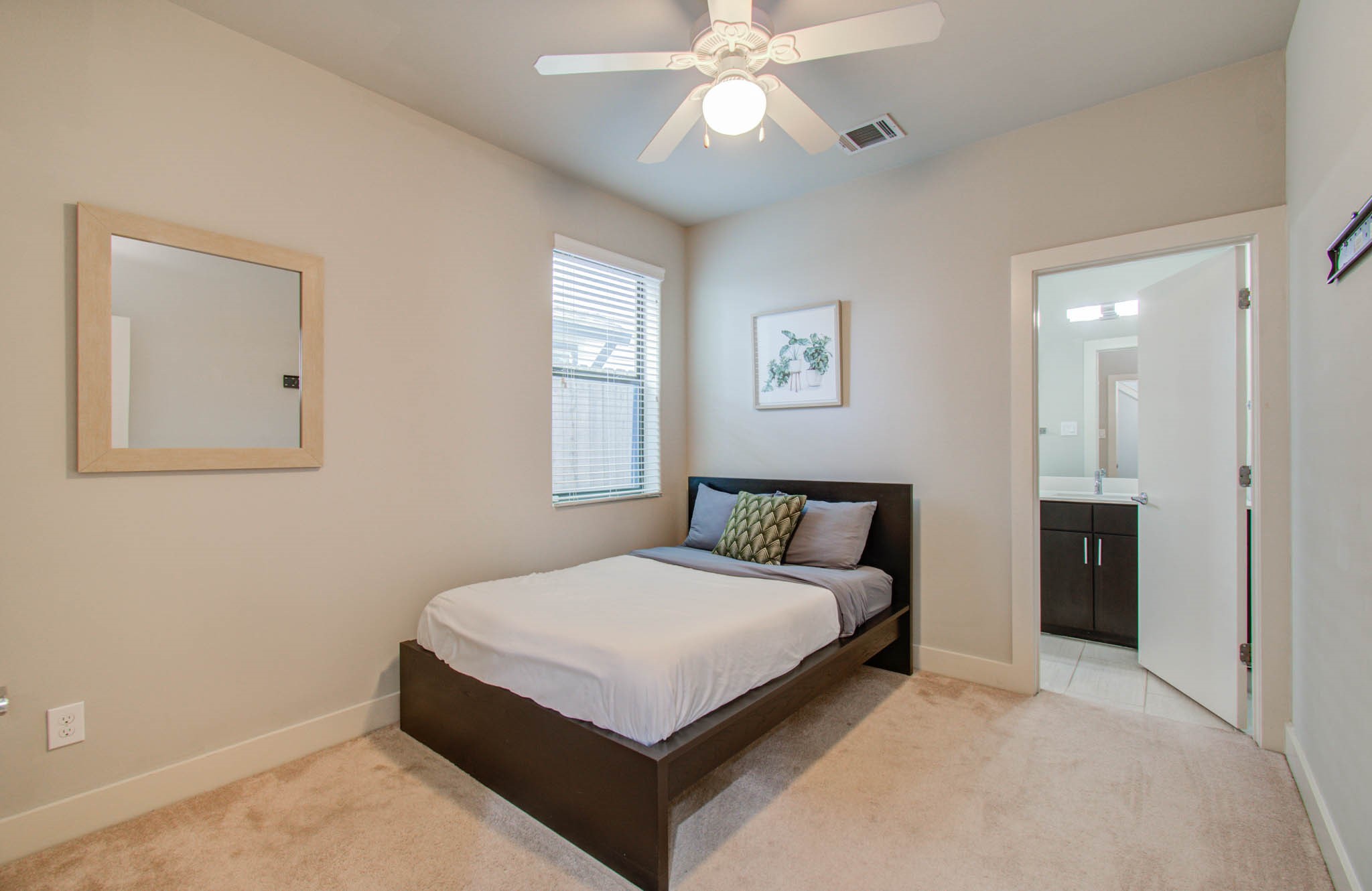 509 Gregg Street Houston, TX 77020 - Photo 7 of 38 a bedroom with a large bed and a chandelier