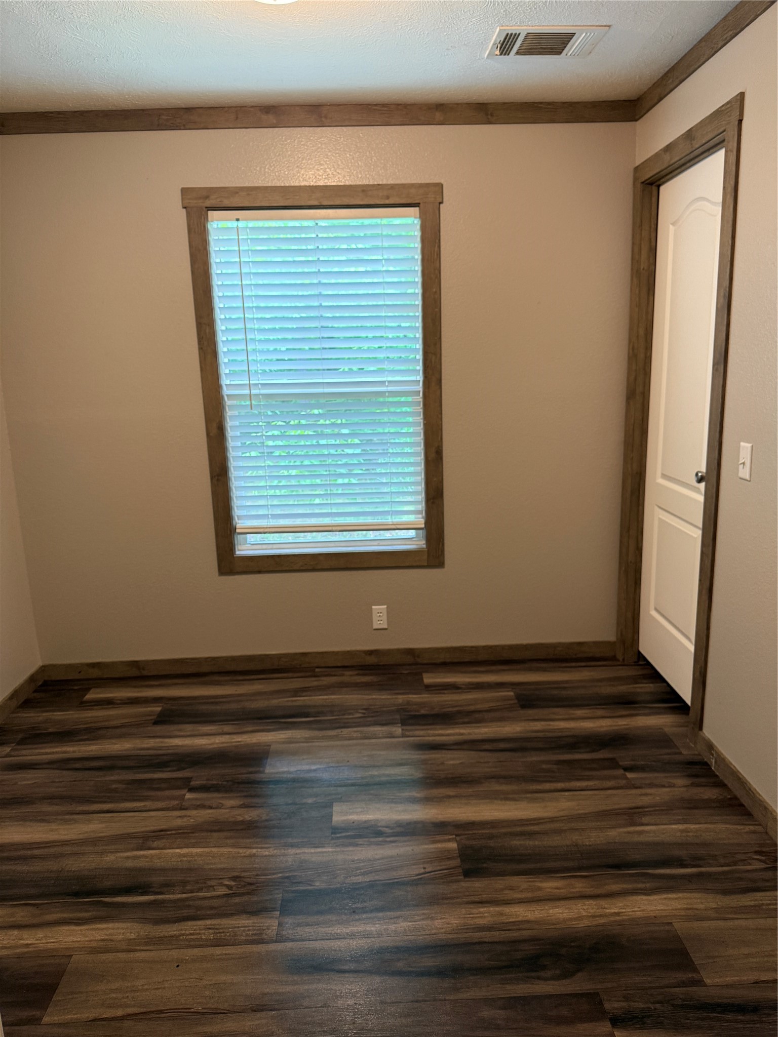105 Saddle Surrey Road Coldspring, TX 77331 - Photo 44 of 48 a view of an empty room with wooden floor and a window