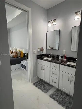 a spacious bathroom with a double vanity sink and a mirror