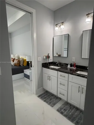 a spacious bathroom with a double vanity sink and a mirror
