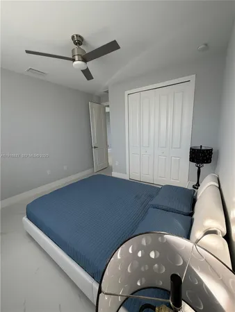 a living room with furniture and a ceiling fan