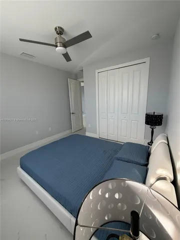 a living room with furniture and a ceiling fan