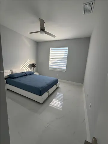 a bedroom with a bed and window