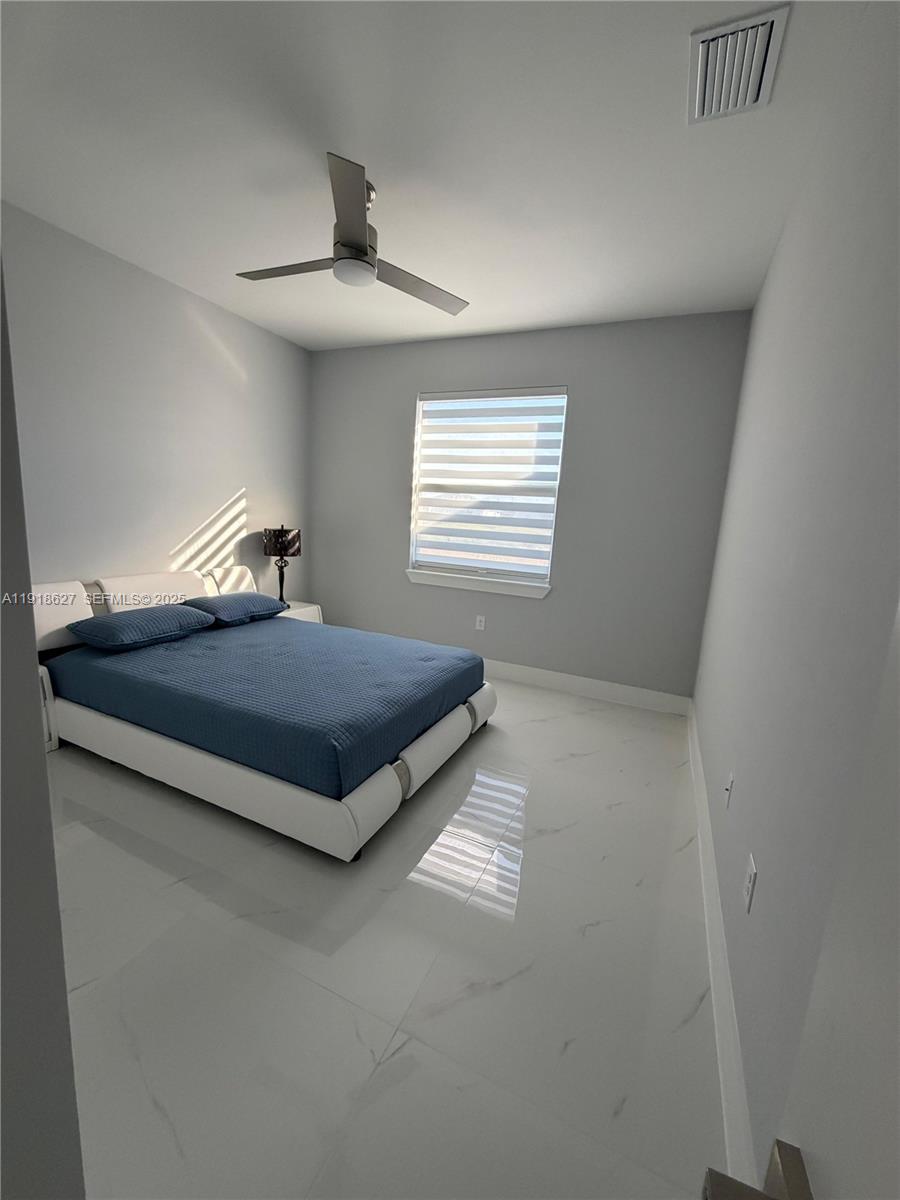 2923 22nd Street Southwest Lehigh Acres, FL 33976 - Photo 16 of 24 a bedroom with a bed and window