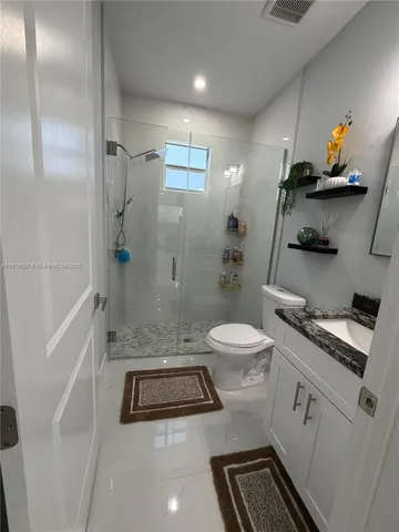 a bathroom with a toilet a sink and shower
