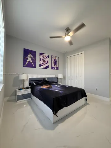 a bed sitting in a bedroom and night stand