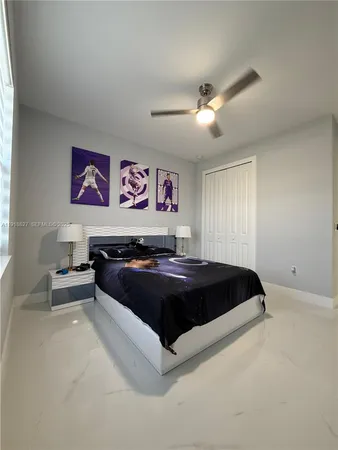 a bed sitting in a bedroom and night stand