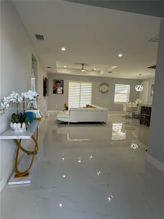 a living room with kitchen island furniture and a chandelier