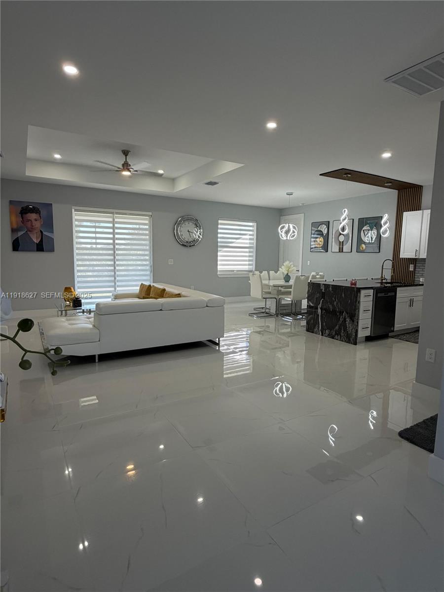 2923 22nd Street Southwest Lehigh Acres, FL 33976 - Photo 3 of 24 a living room with furniture and a flat screen tv
