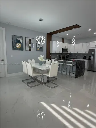 a living room with lots of furniture and kitchen view