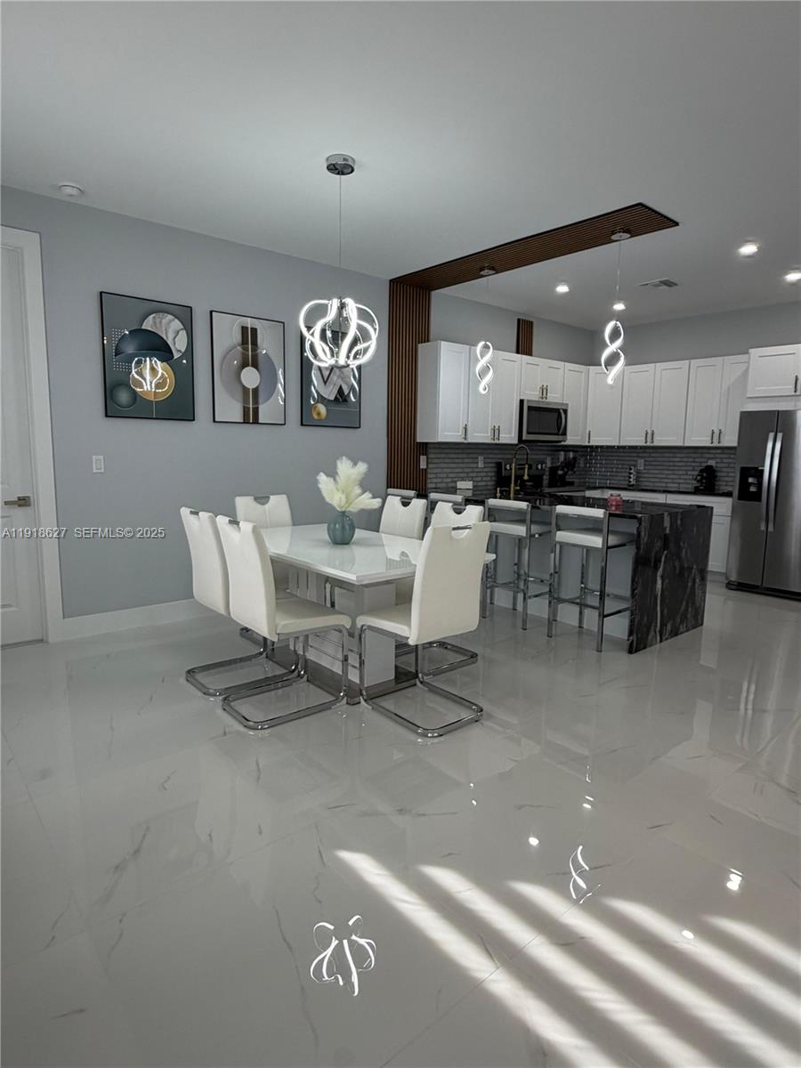 2923 22nd Street Southwest Lehigh Acres, FL 33976 - Photo 4 of 24 a living room with lots of furniture and kitchen view