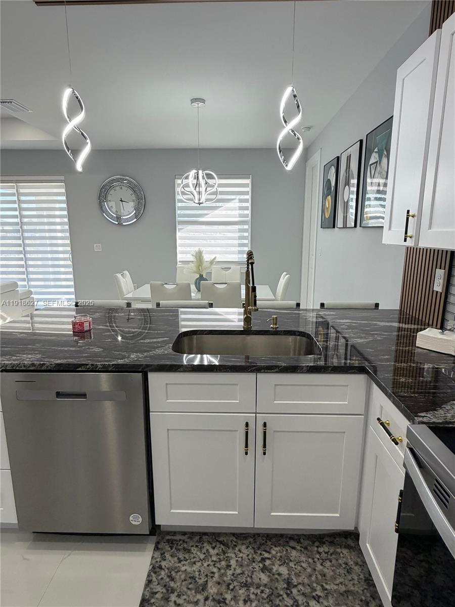 2923 22nd Street Southwest Lehigh Acres, FL 33976 - Photo 6 of 24 a kitchen with granite countertop a sink and cabinets
