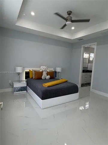 a bedroom with a bed and a ceiling fan