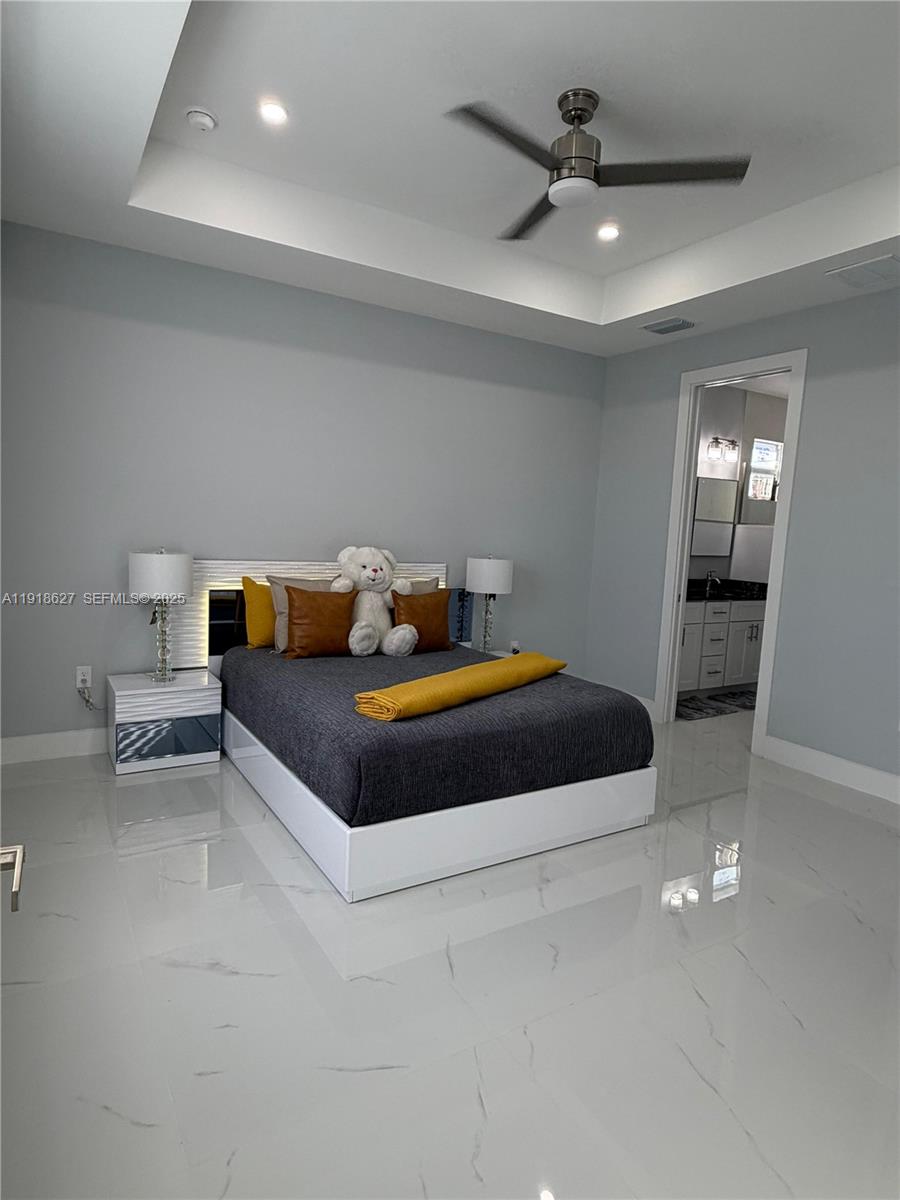 2923 22nd Street Southwest Lehigh Acres, FL 33976 - Photo 8 of 24 a bedroom with a bed and a ceiling fan