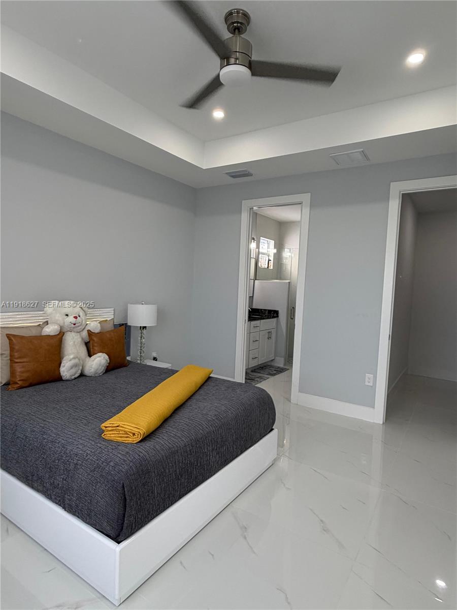 2923 22nd Street Southwest Lehigh Acres, FL 33976 - Photo 9 of 24 a bedroom with a bed and a chandelier