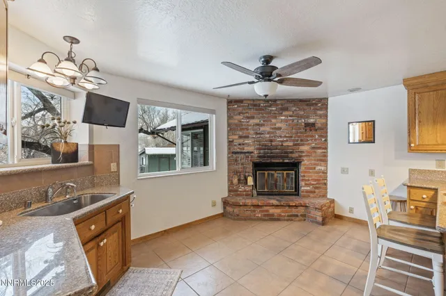a front view of house with yard and trees in the background