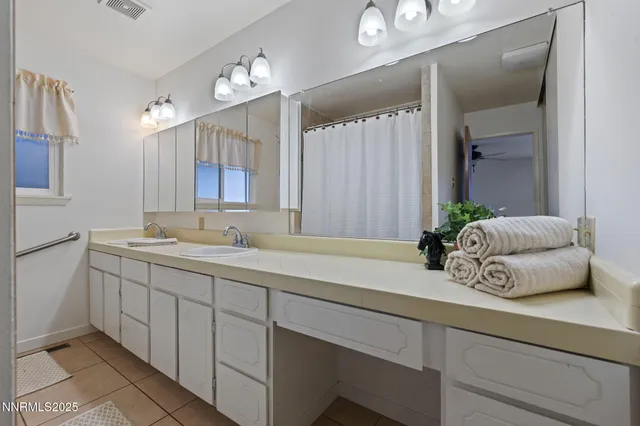 a view of an empty room with wooden floor and a fireplace