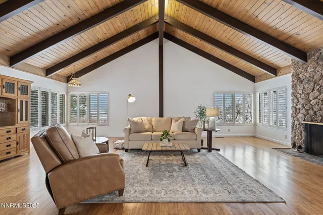 a living room with furniture wooden floor and a table