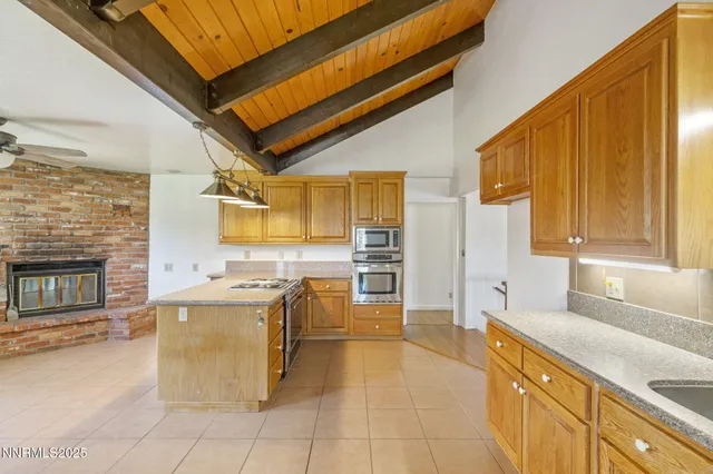 a view of a dry field with mountains in the background