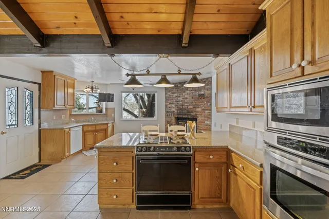 a kitchen with granite countertop a stove top oven and cabinets