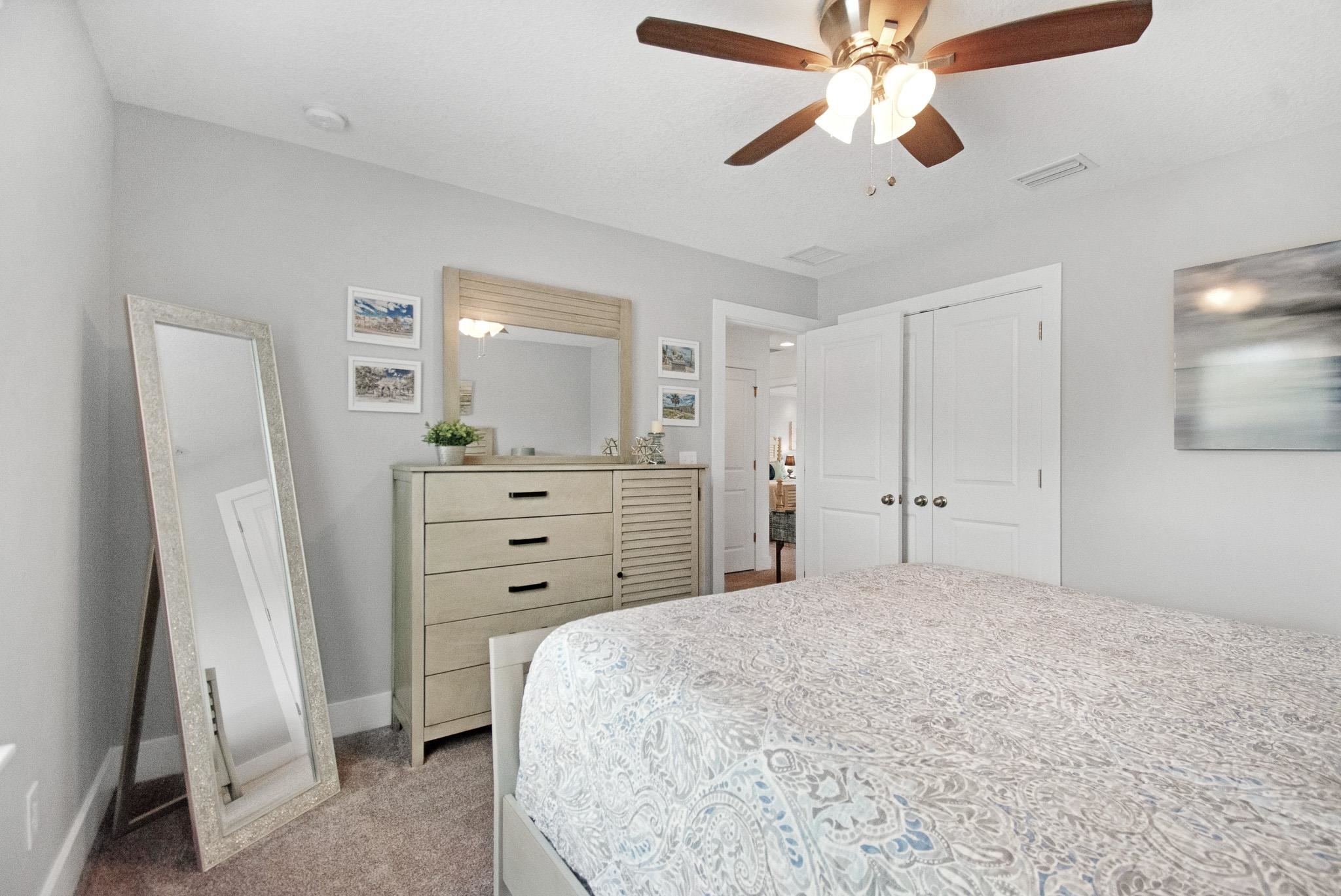 13 Court Edna St. Augustine, FL 32084 - Photo 23 of 59 a bedroom with a bed and a chandelier