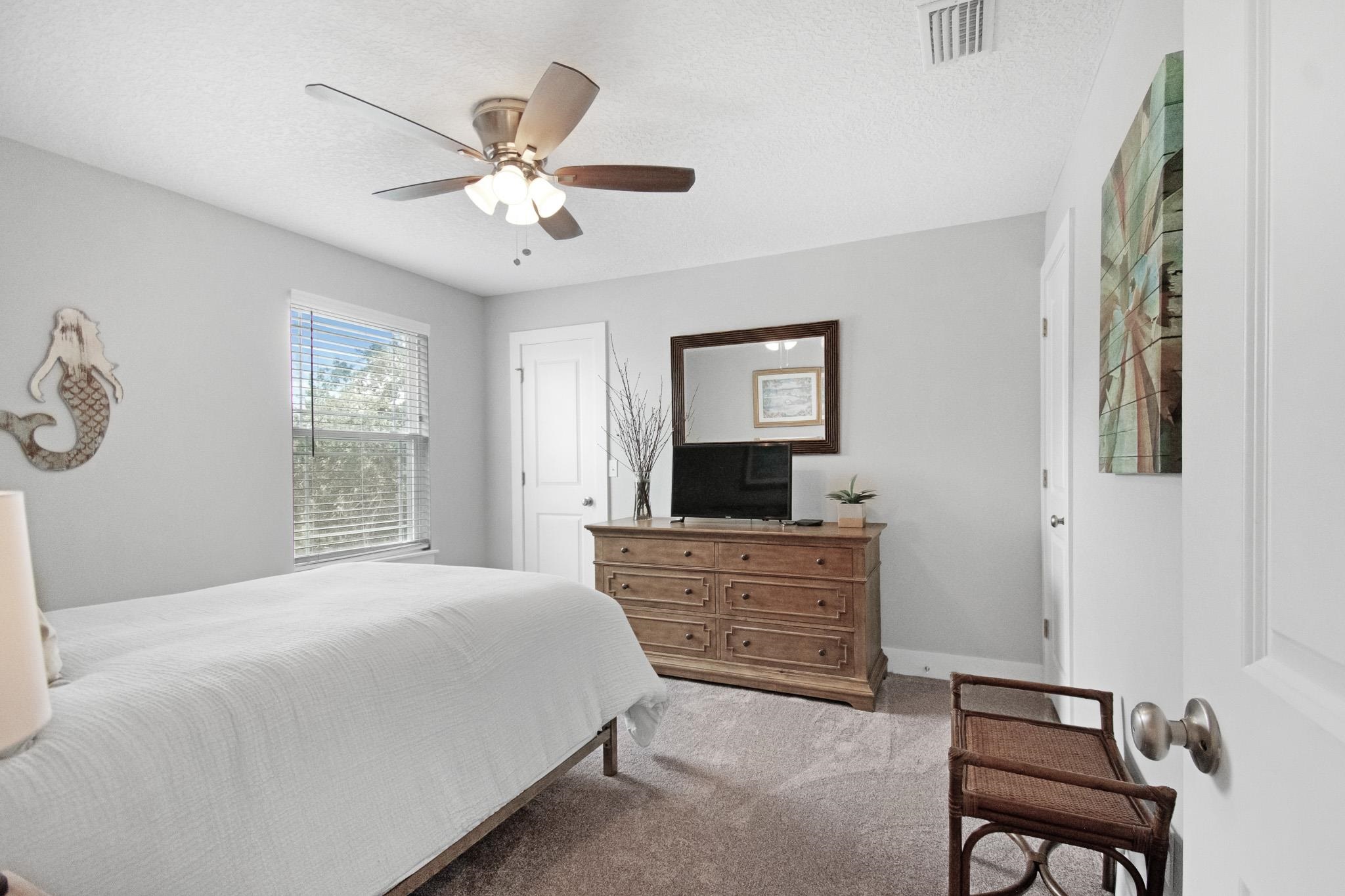 13 Court Edna St. Augustine, FL 32084 - Photo 25 of 59 a bedroom with a large bed and a tv