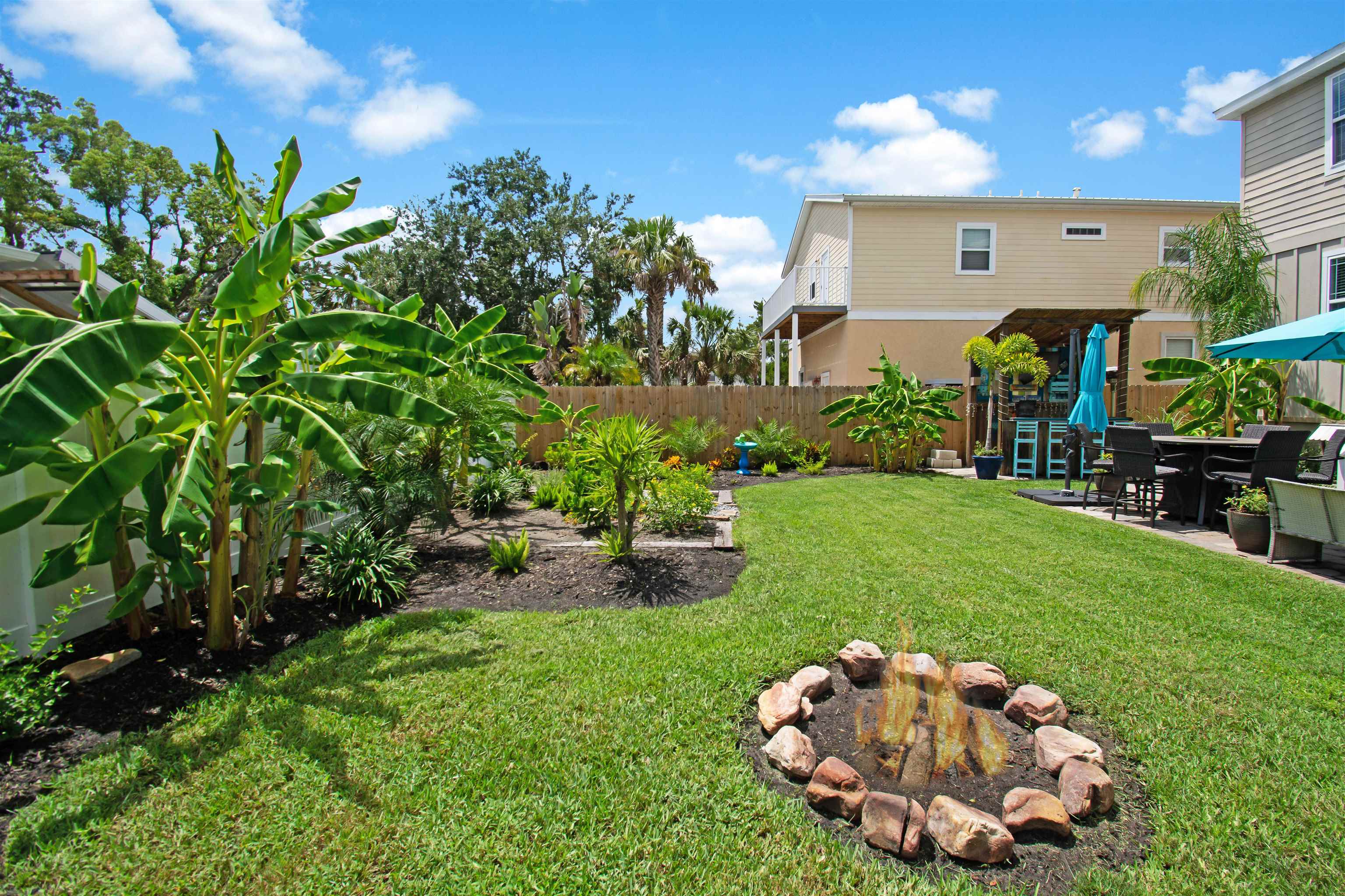 13 Court Edna St. Augustine, FL 32084 - Photo 34 of 59 a view of a backyard with plants and a patio