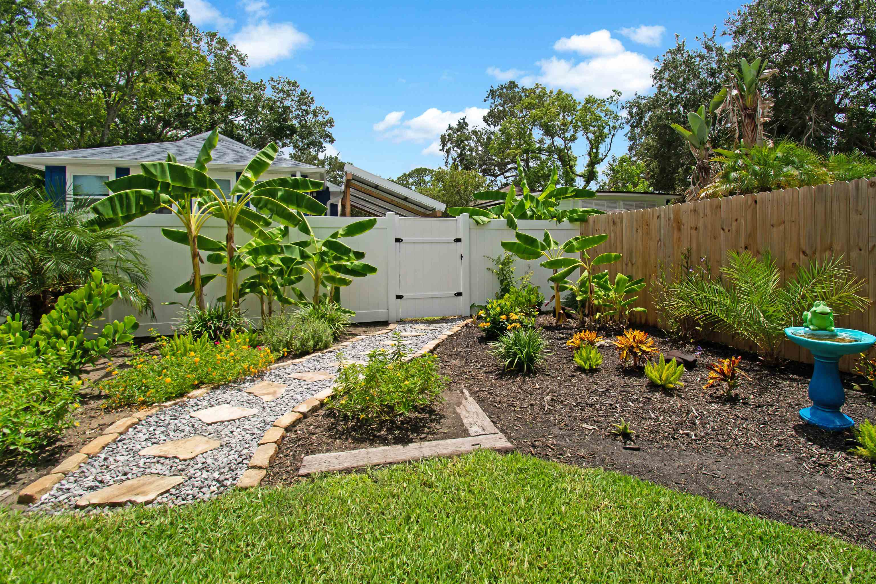 13 Court Edna St. Augustine, FL 32084 - Photo 40 of 59 a view of a garden with plants and large trees