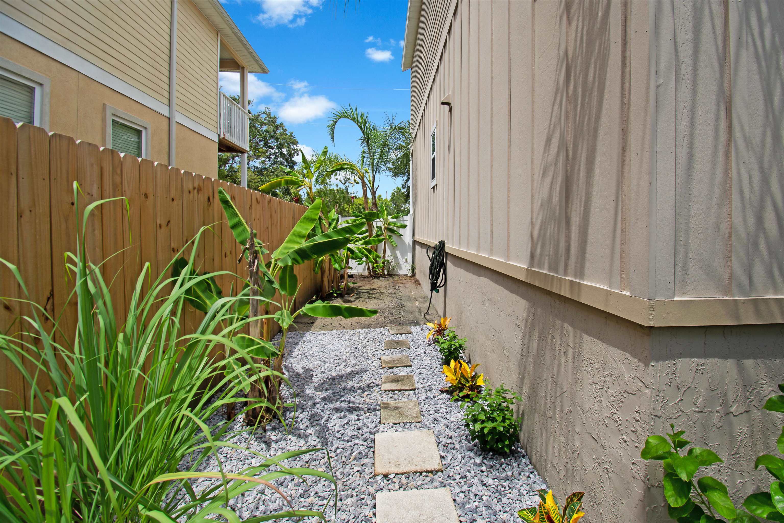 13 Court Edna St. Augustine, FL 32084 - Photo 41 of 59 a backyard with potted plants and wooden fence