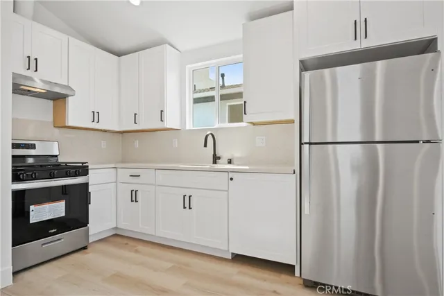a white refrigerator freezer sitting inside of a kitchen